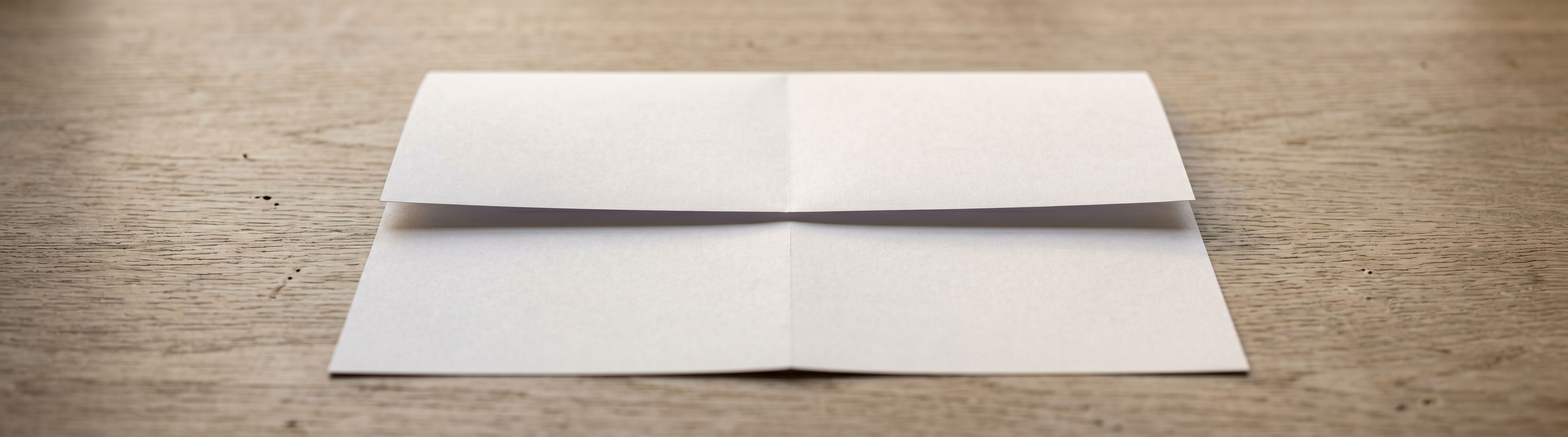 Paper folded with the top edge meeting the centre line