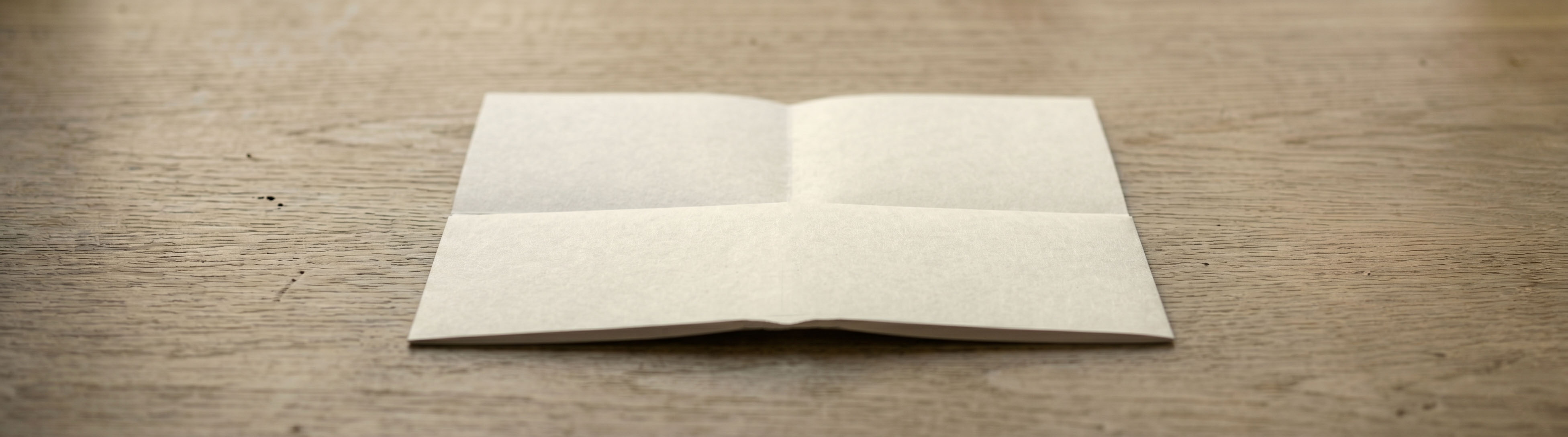 Paper turned over with the bottom edge meeting the centre line
